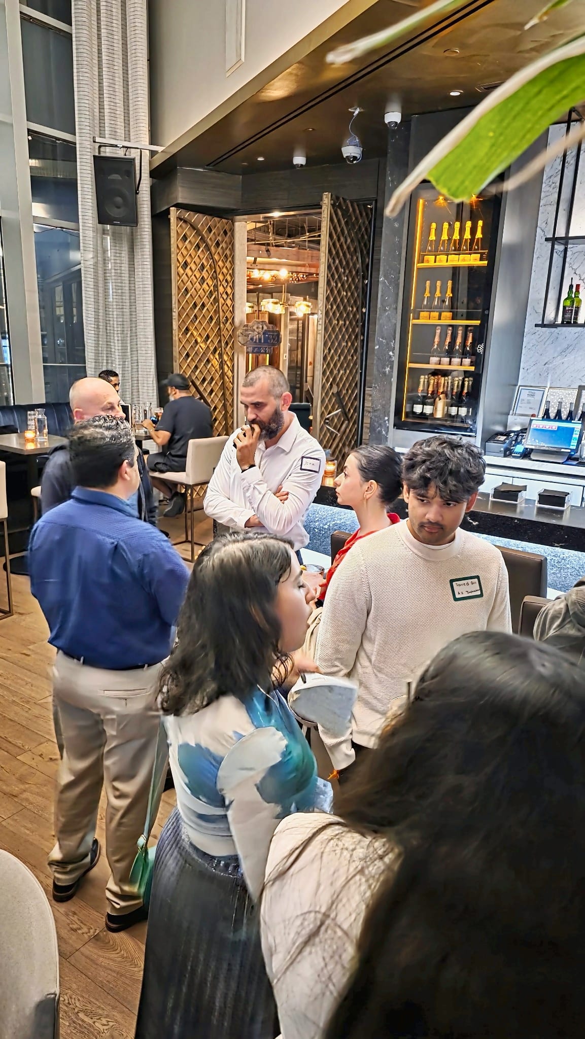 Guests networking near the bar at Karma Lounge during the September night