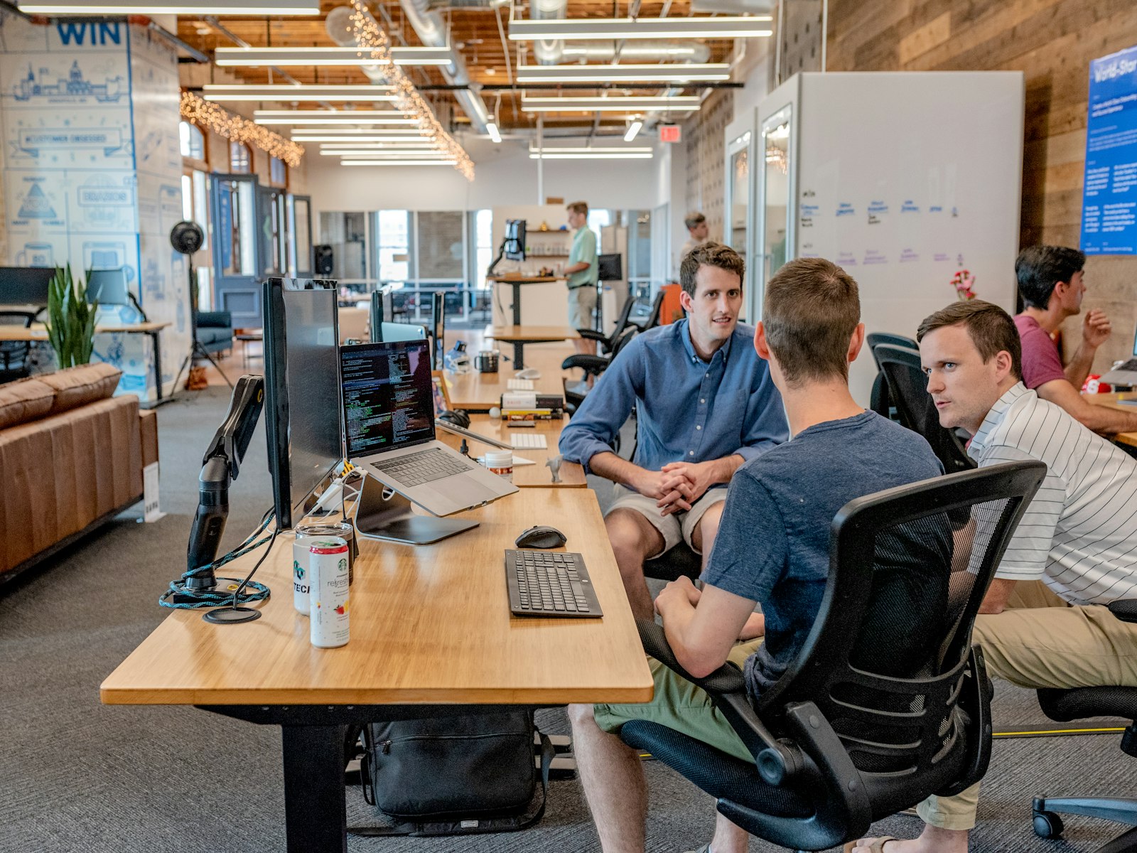Professionals continuing networking conversations over laptops after a Vancouver event