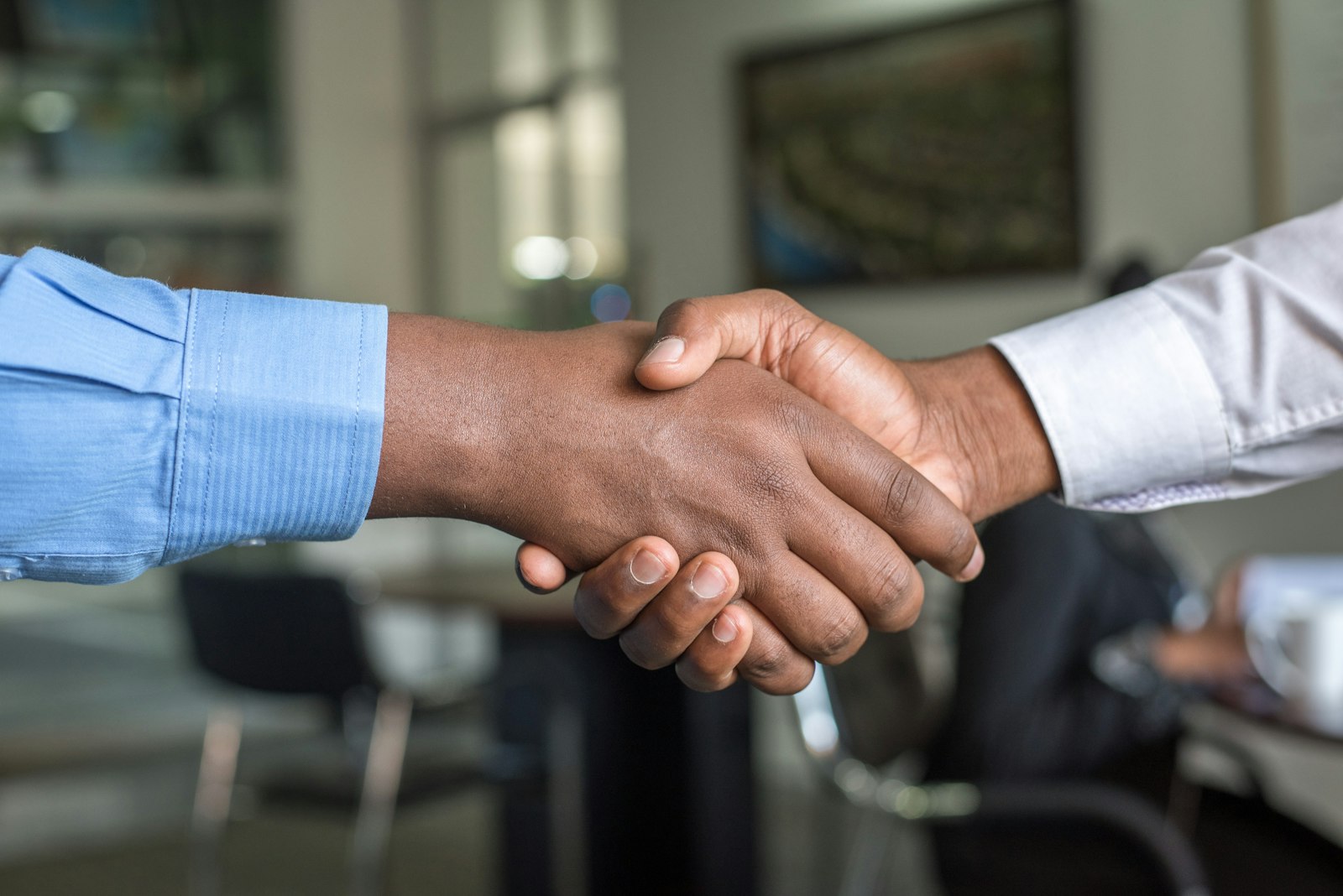 Two professionals shaking hands at a Vancouver business networking event